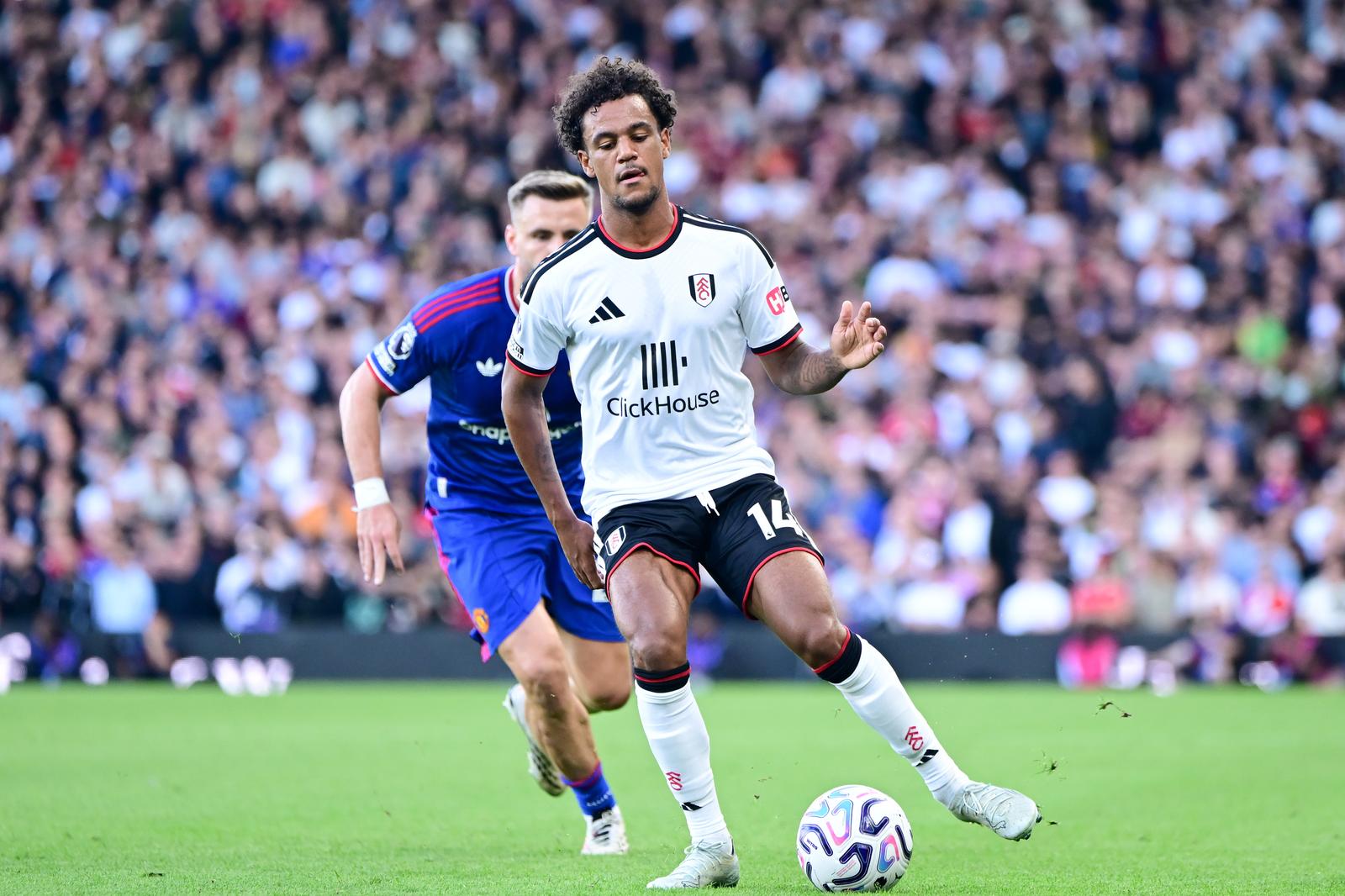 Fulham midfielder Oscar Bobb (14) under pressure from Manchester United defender Luke Shaw (23)during the Premier League match between Fulham and Manchester United at Craven Cottage, London, UK on 20 September 2026.