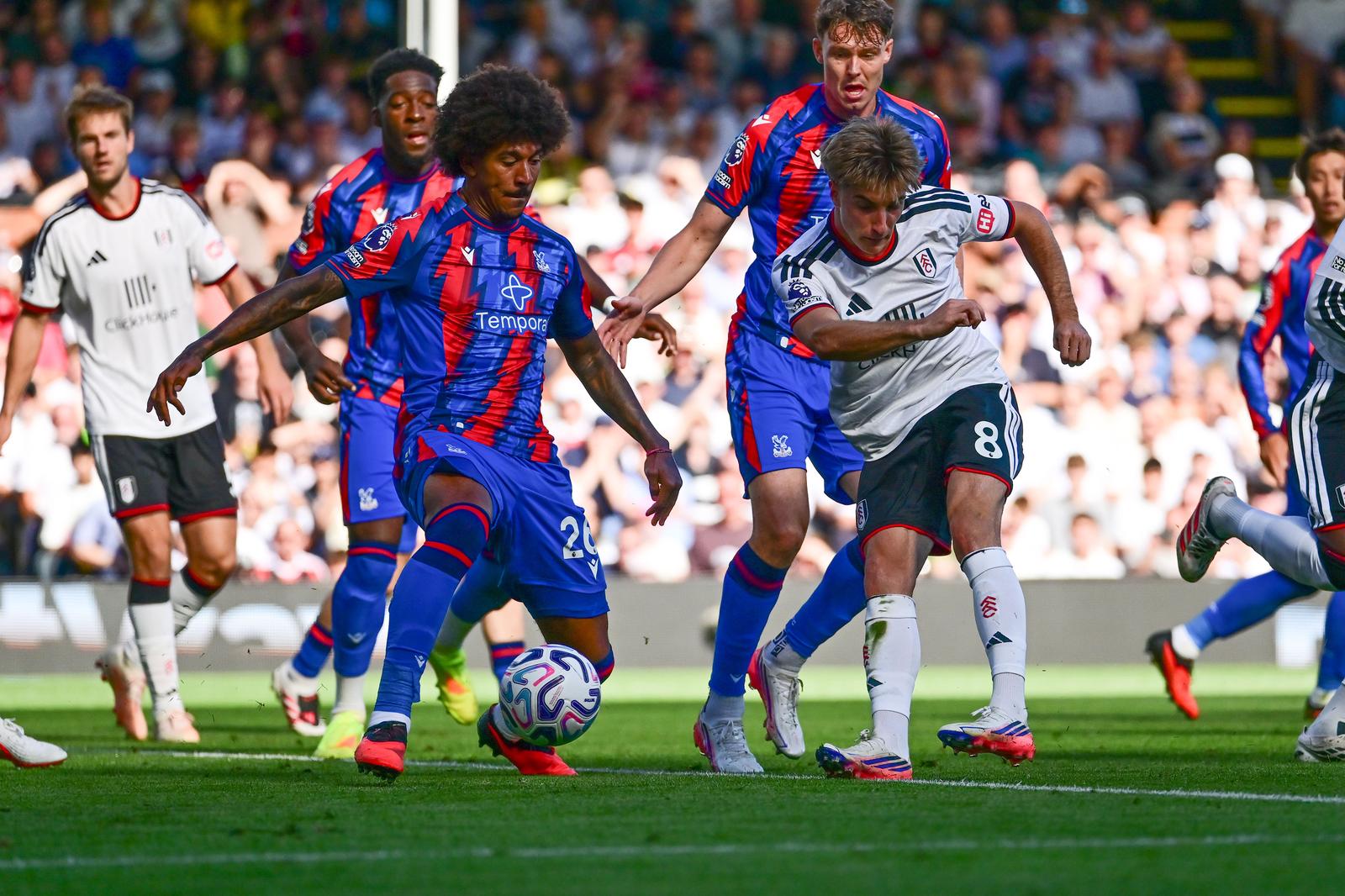 Fulham forward Cesar Palacios (8) takes a shot at goal under pressure from Crystal Palace defender Chris Richards (26) during the Premier League match between Fulham and Crystal Palace at Craven Cottage, London, UK on 5 September 2026.